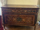 a chest of drawers in the corner of a room