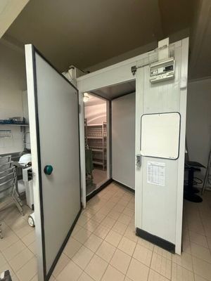 a room with a refrigerator and a table in it
