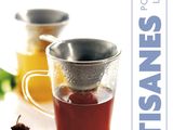 the cover of a book with a cup of tea and a tea strainer