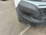 a close up of the front bumper of a white truck
