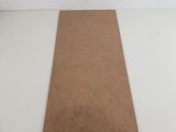 a brown piece of cardboard sitting on top of a white table