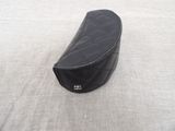 a black bag sitting on the floor next to a white wall