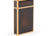 a black and gold cigarette case sitting on top of a white surface