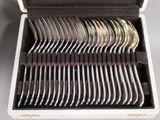 a box with a bunch of silver spoons inside of it