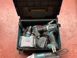 a tool box full of power tools on the floor