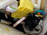 a plastic basket full of laundry items in it