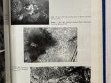 an open book with black and white photos of a forest