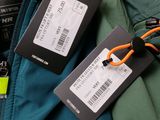 two luggage tags attached to the back of a jacket