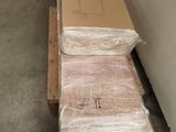 a stack of boxes sitting on the floor next to a wall