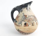 a black and white vase with a painting on it