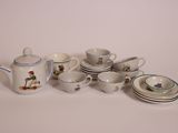 many cups and saucers that are sitting on the table