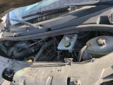 a car engine with the hood open on the street