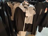 a lot of clothes hanging on a rack in a store
