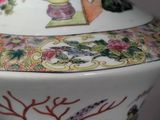 a vase with a painting on it sitting on a table