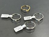 three rings with tags on them are sitting on a table