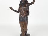 bronze statue of a woman holding her hands up in the air