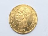 a close up of a gold coin on a white surface