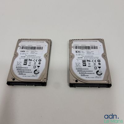 two hard drives sitting side by side on a white surface