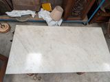 a marble table that is sitting in the middle of a room