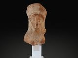a statue of a woman ' s head on a white pedestal