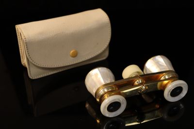 a pair of binoculars sitting on a table next to a wallet