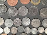 a lot of different coins that are on the table