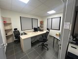 an image of an office with a desk and chairs
