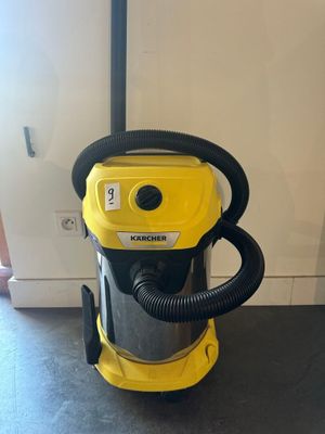 a yellow vacuum cleaner sitting on top of a black floor
