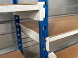 a blue shelf with two shelves on it in a room