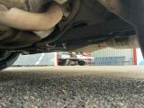 a close up of a car ' s exhaust pipe on the ground