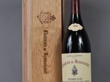 a bottle of wine sitting next to a wooden box