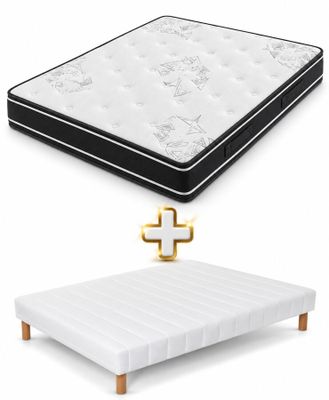 a white mattress and a black and white bed with a gold cross on it