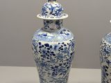 two blue and white vases sitting on a table
