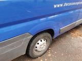 a blue van that is parked on the side of the road