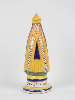a ceramic figurine of a woman with a crown on her head