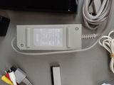 a charger that is sitting on a table next to other electronics