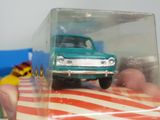 a small toy truck in a clear box on a table