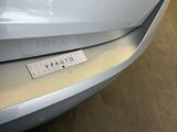 a sticker on the front of a white car