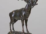 bronze sculpture of a stag with antlers on a rock