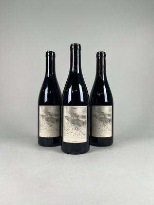 three bottles of wine sitting on top of a table
