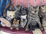 a statue of a group of cats sitting on a couch
