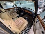 a car that is parked in a lot with its doors open