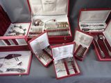many different types of silverware in a red case