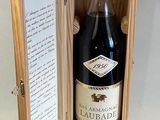 a bottle of wine in a wooden box on a table