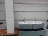 a picture of a bathroom with two sinks and a refrigerator