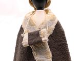 un mannequin vêtu d'un manteau à capuche et d'un chapeau