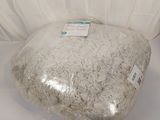 a large rock sitting on top of a white sheet