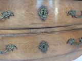 an image of a wooden dresser with brass handles