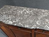 a marble top on a wooden cabinet in a room