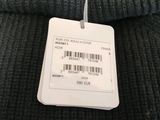 a label on the back of a sweater that is hanging on a hanger